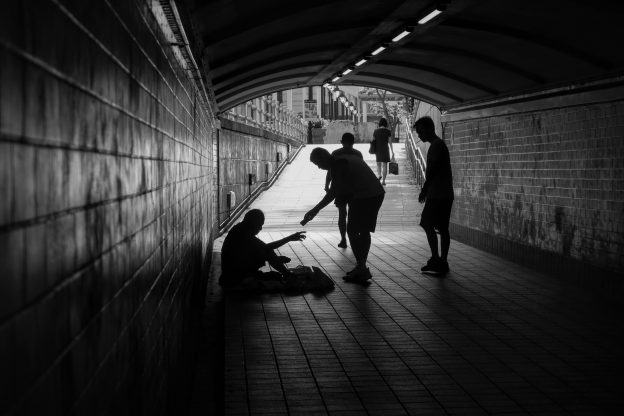 Inequality-Picture by Elise Chia shows beggar who receives some money from a better off person
